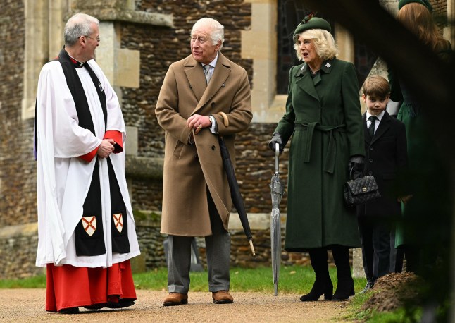 Britain's King Charles III and Britain's Queen Camilla react as they talk with Reverend Canon Paul Williams after attending the Royal Family's traditional Christmas Day service at St Mary Magdalene Church in Sandringham, Norfolk, eastern England, on December 25, 2024. (Photo by Oli SCARFF / AFP) (Photo by OLI SCARFF/AFP via Getty Images)