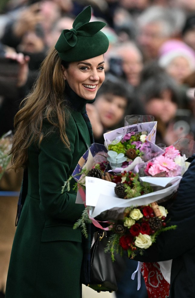 (FILES) Britain's Catherine, Princess of Wales reacts as she is presented with flowers after attending the Royal Family's traditional Christmas Day service at St Mary Magdalene Church in Sandringham, Norfolk, eastern England, on December 25, 2024. Catherine, Princess of Wales celebrates her 43rd birthday on January 9, 2024, seeking to turn the page on a turbulent year which saw her retreat from public life to fight cancer. Kate, as she is commonly known, is expected to step up her royal engagements in 2025 after announcing in September that she had completed chemotherapy for an unspecified cancer. (Photo by Oli SCARFF / AFP) (Photo by OLI SCARFF/AFP via Getty Images)