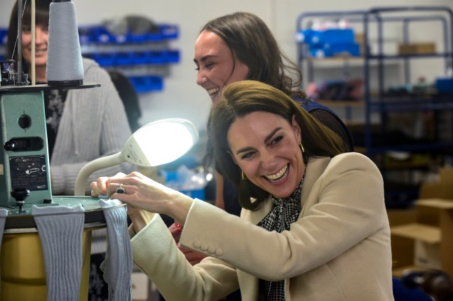AMMANFORD, WALES - JANUARY 30: Catherine, Princess of Wales spends time with members of the production team on the factory floor during a visit to Corgi, a family run textiles manufacturer focused on the production of socks and knitwear on January 30, 2025 in Ammanford, Wales. During her visit to South Wales, The Princess of Wales she highlighted the work of longstanding organisations that prioritise community at their core. The Princesses focus was on the wellbeing of children and families, as well as celebrating the excellence of Welsh textiles manufacturing. (Photo by Rebecca Naden - WPA Pool/Getty Images)