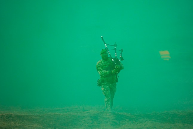 A Scottish piper attached to British troops plays the pipe at the end of the Steadfast Dart 2025 exercise