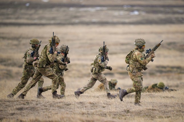 Servicemen run during the Steadfast Dart 2025 exercise,
