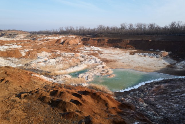 A vast open-pit mine stretches across the landscape on February 12, 2025