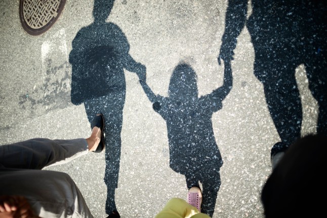 Mother, Father And Son Holding Hands.