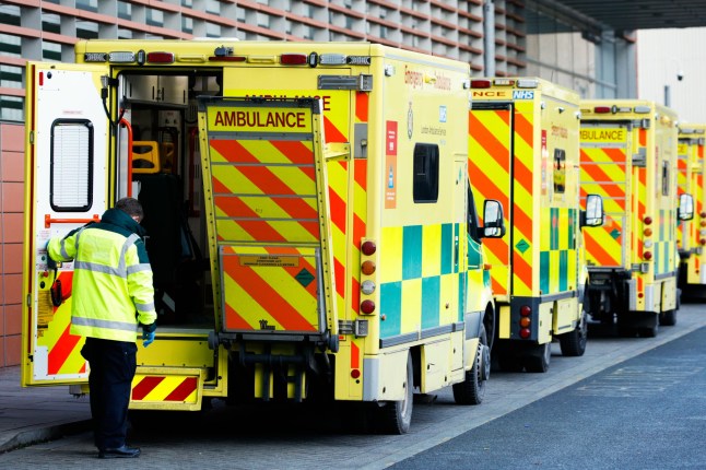 A paramedic lowers the loading platform of an ambulance outside the emergency department of the Royal London Hospital in London, England, on January 25, 2021