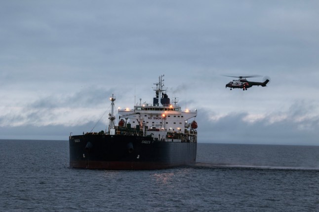 epa11795847 A handout photo made available by Finnish Border Guard shows a helicopter used by the authorities during an operation to transfer the Eagle S tanker from the Gulf of Finland to Svartbeck inner anchorage near the port of Kilpilahti, Finland, 28 December 2024. Finnish authorities are investigating the Eagle S, an oil tanker registered with the Cook Islands, suspected of having caused the outage of an undersea power cable connecting Finland and Estonia on 25 December. EPA/FINNISH BORDER GUARD HANDOUT HANDOUT EDITORIAL USE ONLY/NO SALES
