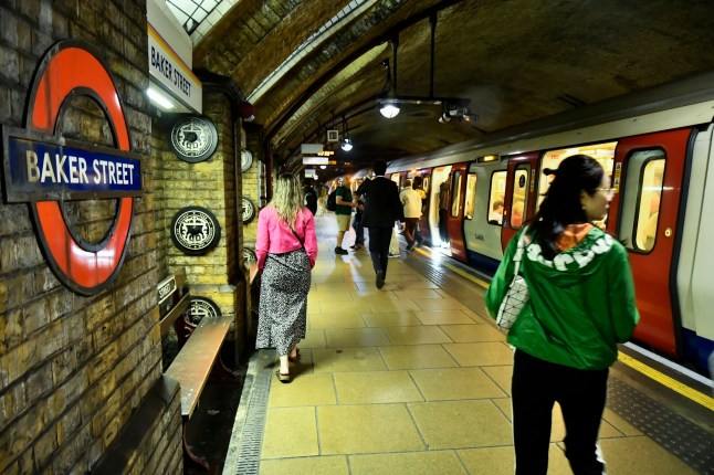 Baker Street London Underground station platform with Tube train and passengers.