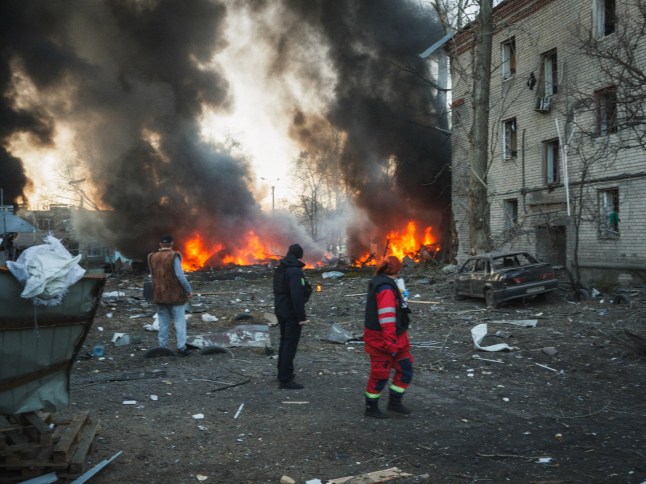 KHARKIV, UKRAINE - MARCH 07: Emergency teams and civilians are at the scene where a Russian Iskander missile hit a civilian infrastructure facility, causing an explosion and therefore fire and damage in ten garages and five cars in Kharkiv, Ukraine on March 07, 2025. A woman was pulled from the rubble of the building, alive, and is currently being examined by doctors. (Photo by George Ivanchenko/Anadolu via Getty Images)