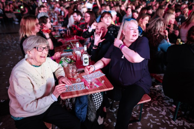 ? Joel Goodman - 07973 332324 - all rights reserved . 08/03/2025. Liverpool , UK . Long-standing bingo player ANNE GANDY MBE (97) and her daughter DONNA PITMAN (59) play. A Bongo's Bingo night at the ACC Exhibition Centre in Liverpool. The organisers say 3,500 people had paid for tickets for the business' 10th Anniversary event, which sees traditional bingo paired with novelty prizes, nostalgic 1980s and 1990s music, dance and stage performances.. Photo credit : Joel Goodman