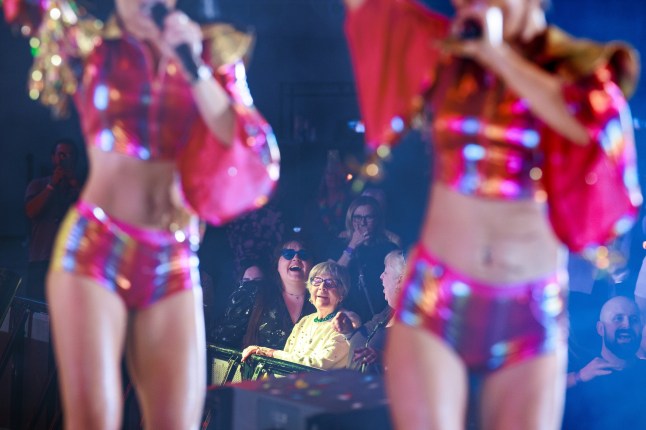 ? Joel Goodman - 07973 332324 - all rights reserved . 08/03/2025. Liverpool , UK . Long-standing regular ANNE GANDY MBE (97) stands at the front of the crowd at the barrier to the stage's pit to watch the Cheeky Girls perform. A Bongo's Bingo night at the ACC Exhibition Centre in Liverpool. The organisers say 3,500 people had paid for tickets for the business' 10th Anniversary event, which sees traditional bingo paired with novelty prizes, nostalgic 1980s and 1990s music, dance and stage performances.. Photo credit : Joel Goodman