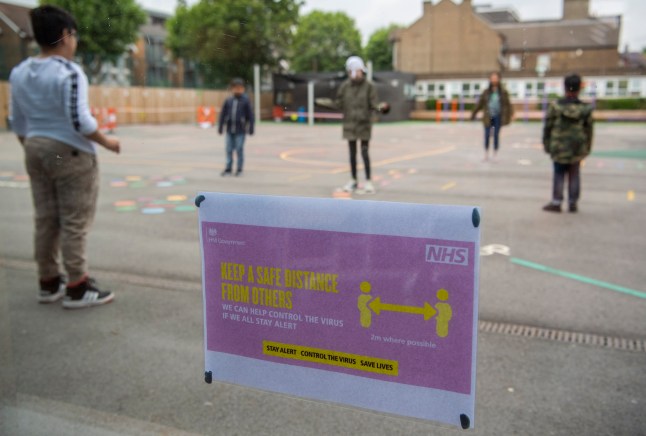 LONDON, ENGLAND - JUNE 10: Children maintain social distancing measures while playing in the playground at Earlham Primary School, which is part of the Eko Trust on June 10, 2020 in London, England. As part of Covid-19 lockdown measures, Earlham Primary School is teaching smaller ???bubbles??? of students, to help maintain social distancing measures. School staff have put into place many safety measures such as corridor signage for a one way system, regular supervised handwashing, temperature checks on arrival and enhanced cleaning regimes to keep pupils and staff as safe as possible. Bubbles of pupils are limited to six and each have their own well-ventilated space. The Government have announced it is set to drop plans for all English primary pupils to return to school before the end of the summer. (Photo by Justin Setterfield/Getty Images)