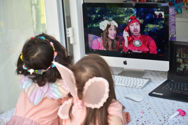 BUCKINGHAMSHIRE, UNITED KINGDOM - MAY 14: Twin sisters, daughters of the photographer, enjoy a Zoom party for their fourth birthday, hosted by children's entertainers 'Party on a Cloud', on May 14, 2020 in Buckinghamshire, United Kingdom. The prime minister announced the general contours of a phased exit from the current lockdown, adopted nearly two months ago in an effort curb the spread of Covid-19. (Photo by Jim Dyson/Getty Images)