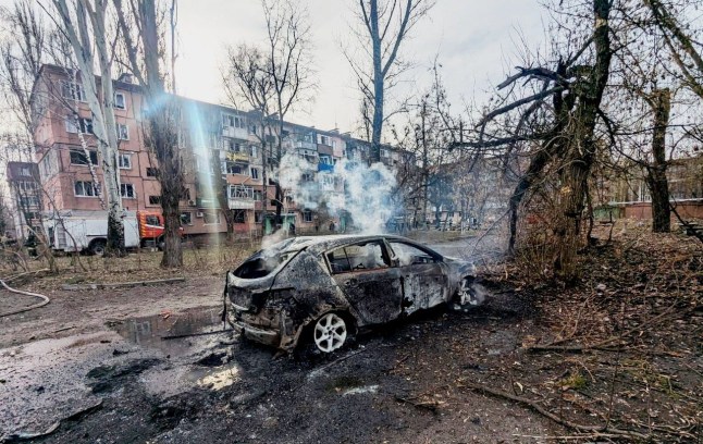 A burning car is seen in front of an apartment building damaged by a Russian missile strike, amid Russia's attack on Ukraine, in Kryvyi Rih, Ukraine March 12, 2025. Press service of the State Emergency Service of Ukraine in Dnipropetrovsk region/Handout via REUTERS THIS IMAGE HAS BEEN SUPPLIED BY A THIRD PARTY. DO NOT OBSCURE LOGO.