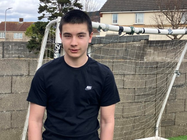 Kian Mills, 15, with his parents Julie and Aldon at home in Port Talbot. Kian is home educated after his parents took him out of St Joseph's Catholic School in June 2024. Credit: WalesOnline/Media Wales