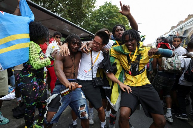 Revellers dance during the Notting Hill Carnival parade, in London, Britain, on August 26, 2024. REUTERS/Hollie Adams
