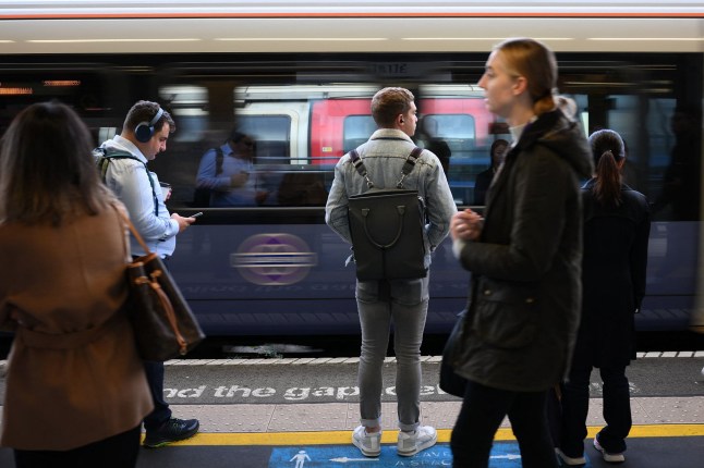 Commuters wait on Elizabeth line platform in London.