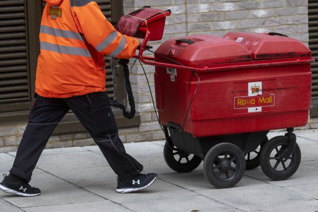 A Royal Mail postperson in London, UK, on Monday, Dec. 16, 2024. The UK government has approved??Daniel Kretinsky's ??3.6 billion ($4.6 billion) takeover of the Royal Mail's parent company, after the Czech billionaire made a series of commitments. Photographer: Jason Alden/Bloomberg via Getty Images