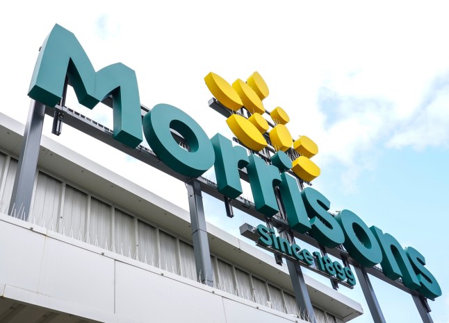 File photo dated 22/08/21 of a Morrisons supermarket store sign. Morrisons has said 365 jobs are at risk of redundancy because of plans to close some of its cafes, convenience stores, florists and fresh food counters. Issue date: Monday March 24, 2025. PA Photo. The supermarket chain said it was costing more to run the services than it was making from customer spending. The closures will see it shut down 52 cafes, all 18 market kitchens, 17 Morrisons Daily convenience stores, 13 florists, 35 meat counters, 35 fish counters and four pharmacies. The majority of staff members affected by the changes are expected to be deployed to roles elsewhere in the business, Morrisons said. But there will be a total of around 365 employees at risk of redundancy. See PA story CITY Morrisons . Photo credit should read: Ian West/PA Wire