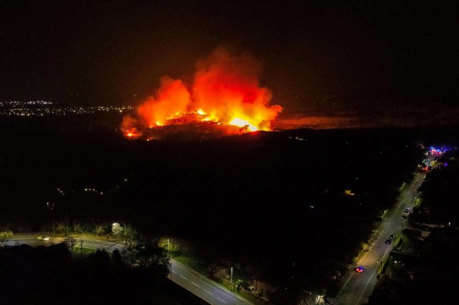 A wildfire in Upton Heath, Poole, Dorset, seen in the distance burning through a nature park.