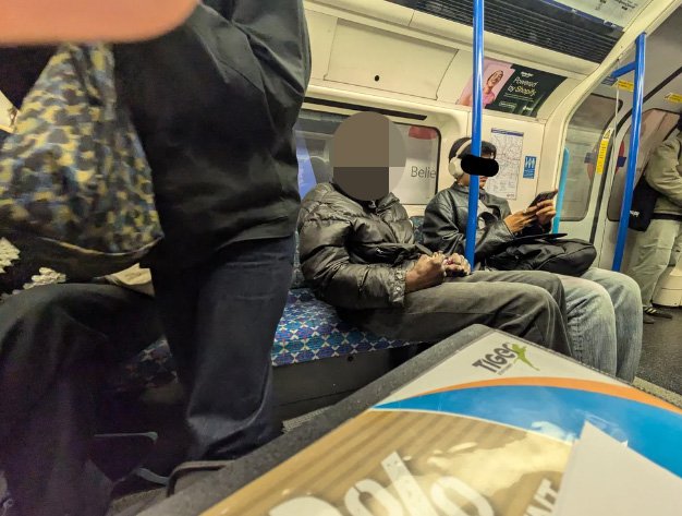A man trying to smoke crack cocaine on the Victoria line Tube carriage.
