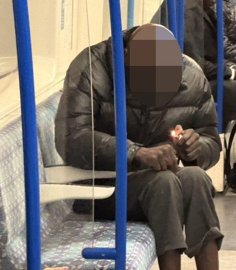 A man trying to smoke crack cocaine on the Victoria line Tube carriage.