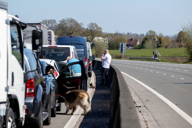 People get out of their cars as traffic is at a standstill, on the anti-clockwise carriageway on the M25 at Westerham. April 7, 2025. Release date ??? April 7, 2025. The M25 has been closed after a lorry caught on fire. The incident took place on the anti-clockwise carriageway in Kent, between Junction 5 and 6, just under an hour ago. Emergency services are on the scene and traffic is at a standstill. Both sides of the motorway were initially closed but sources on the scene say the clockwise carriageway has been re-opened in the last few minutes.