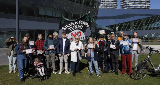 Campaigners protesting outside the City Hall in London against the new Silvertown Tunnel opening.