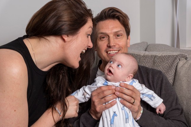 Adam and Lucy Isaac with their son Rafferty (11 weeks old), at home in Sonning, Berkshire. During pregnancy Rafferty was surgically removed and replaced in his mother's womb when it was discovered she had cancerous lesions. Adam had previously had a kidney transplant/ 10-4-2025 pic by Ian McIlgorm