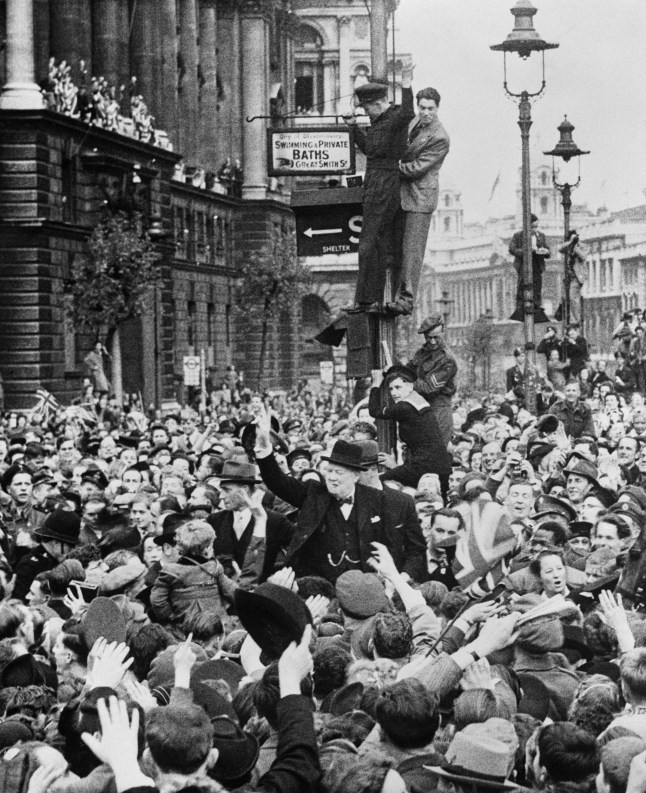 Prime Minister Winston Churchill is mobbed by the excited crowds as he made his triumphant ride to the Houses of Parliament after his victory speech which was relayed to the thousands in Whitehall on V.E. Day.
