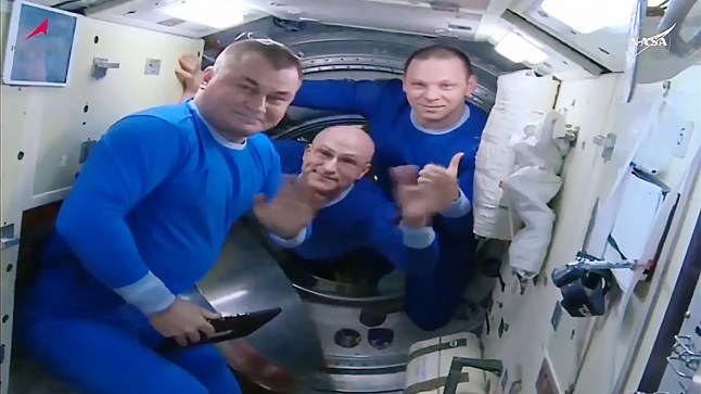 (From left) Alexey Ovchinin of Roscosmos, Don Pettit of NASA, and Ivan Vagner of Roscosmos wave farewell before boarding their Soyuz MS-26 spacecraft for the ride back to Earth. NASA+