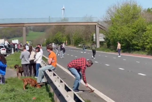 A screengrab of a video showing people on the M6 motorway during a road closure.