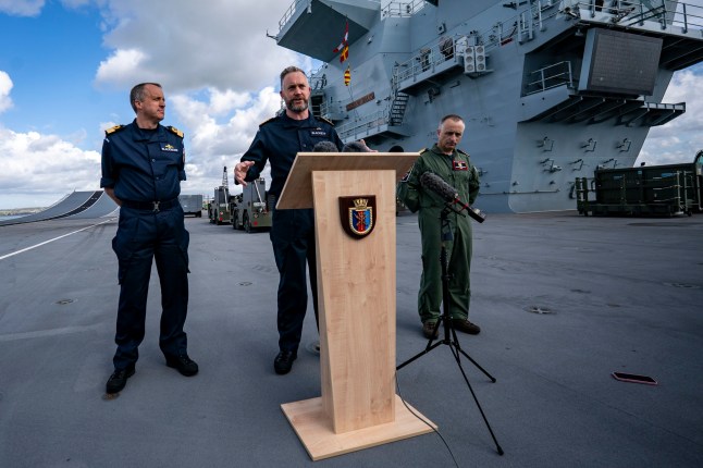 EMBARGOED TO 0001 TUESDAY APRIL 22 Captain Will Blackett RN, Commanding Officer of HMS Prince of Wales, centre, joined by Commodore James Blackmore RN, Commander Carrier Strike Group, left, and Captain Colin McGannity RN, Commander Air Group, right, as they take questions from the media onboard HMS Prince of Wales docked at HM Naval Base Portsmouth, as they prepare the carrier ahead of it deploying as part of the UK Carrier Strike Group to conduct interoperability training and defence engagement in the Indo-Pacific. Picture date: Wednesday April 16, 2025. PA Photo. See PA story DEFENCE Carrier. Photo credit should read: Ben Birchall/PA Wire