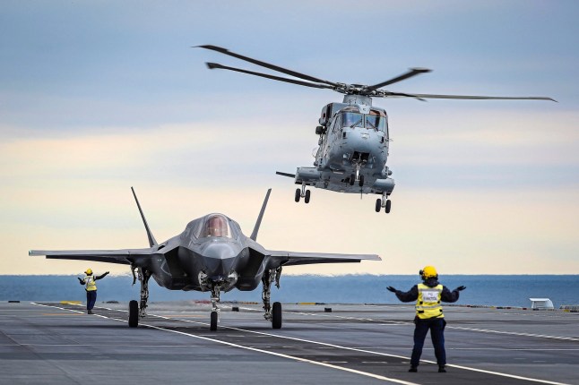epa07095458 A handout picture provided by the British Ministry of Defence (MOD) showing a Merlin Mk4 From 845 Naval Air Squadron taking off in the SAR role as British test pilot Peter Wilson, prepres to take off to conduct the worlds first SRVL in the North Atlantic, 13 October 2018, (issued 15 October 2018). The MOD report first ever Shipborne Rolling Vertical Landing (SRVL) has been carried out by an F-35B Lightning II joint strike fighter jet conducting trials onboard the UK????????s new carrier HMS Queen Elizabeth. The UK is the only nation currently planning to use the manoeuvre, which will allow jets to land onboard with heavier loads, meaning they won????????t need to jettison expensive fuel and weapons before landing. Previously the jets have conducted vertical landings, coming to a hover to the side of the ship, translating sideways over the deck, before gently lowering to land on. It is regarded as a safer method to reduce speed before the jet lands on in this way, rather than landing on at speed, coming to a
