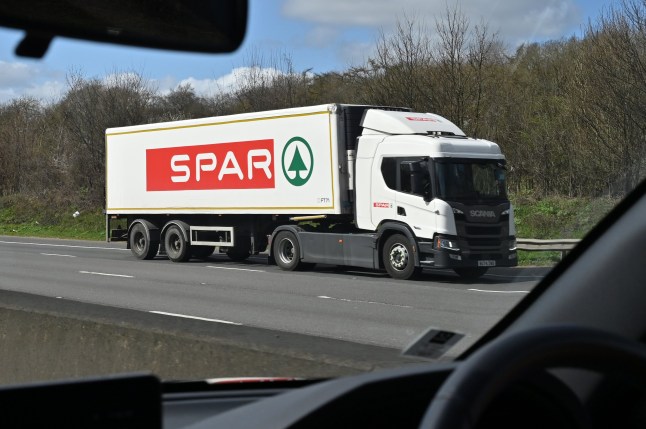 UNSPECIFIED, ENGLAND - MARCH 28: A Spar supermarket branded lorry is photographed travelling along the M25 motorway through a car windscreen on March 28, 2025 in Unspecified, United Kingdom. (Photo by John Keeble/Getty Images)