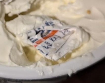 The Sainsbury's shopper's photo of what appears to be a clothing label, embedded in a sealed pot of mascarpone cheese