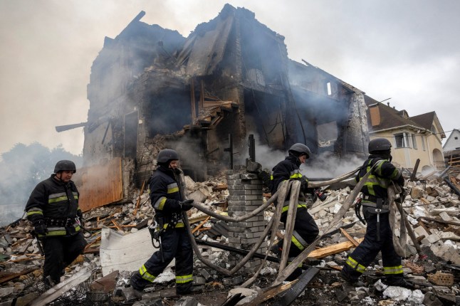 Emergency workers work at the site where private houses were destroyed in a Russian rocket strike, amid Russia's attack on Ukraine, in Markhalivka, Kyiv region, Ukraine, May 25, 2025. REUTERS/Thomas Peter