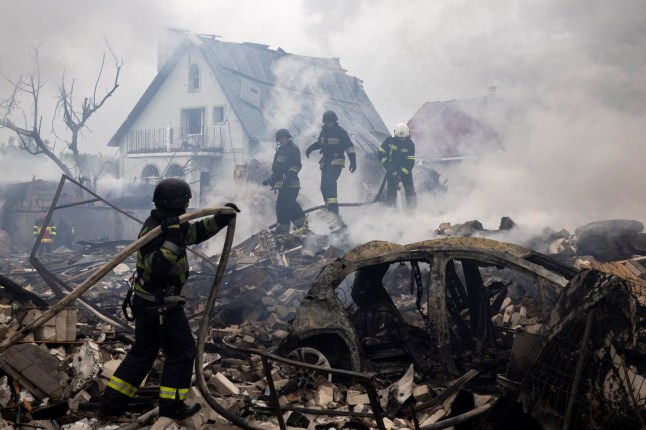 Emergency workers extinguish fire in the debris of a private house that was destroyed in a Russian rocket strike, amid Russia's attack on Ukraine, in Markhalivka, Kyiv region, Ukraine, May 25, 2025. REUTERS/Thomas Peter
