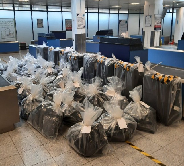 Seizures made by the UK authorities are organised on the floor at an airport (Picture: National Crime Agency)