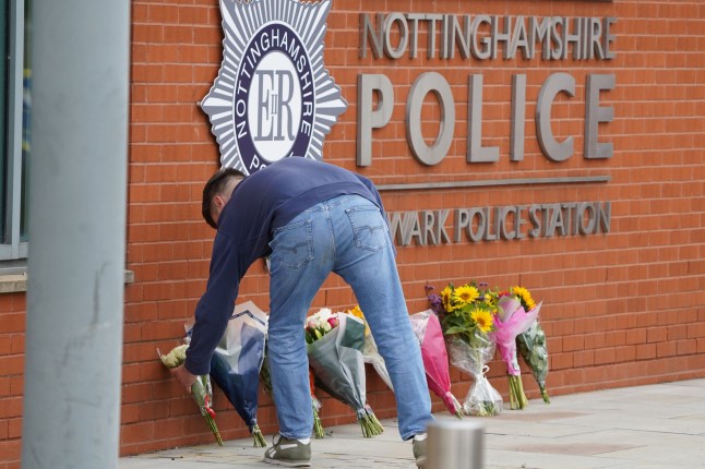 A man leaves floral tributes outside Newark Police station. Sergeant Graham Saville, 46 was struck by a train and later died when trying to help a member of the public. August 30 2023