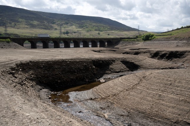 The bed of Woodhead Reservoir is revealed by a falling water level, near Glossop, northern England on May 22, 2025. Data from United Utilities, the United Kingdom's largest listed water company, shows that reservoir levels for the north west of England stands at 61.9% of capacity, down from 88.8% at the same period in 2024. (Photo by Oli SCARFF / AFP) (Photo by OLI SCARFF/AFP via Getty Images)