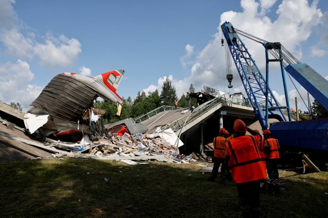 Specialists of emergency services work at the scene, after a road bridge collapsed onto railway tracks derailing an approaching train in the Bryansk region, Russia, June 1, 2025. REUTERS/Stringer