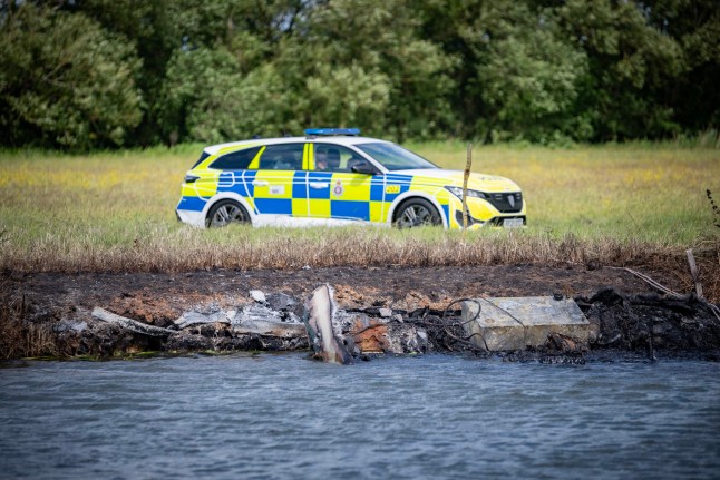 A police car on the shore of River Thames after a boat reportedly exploded.