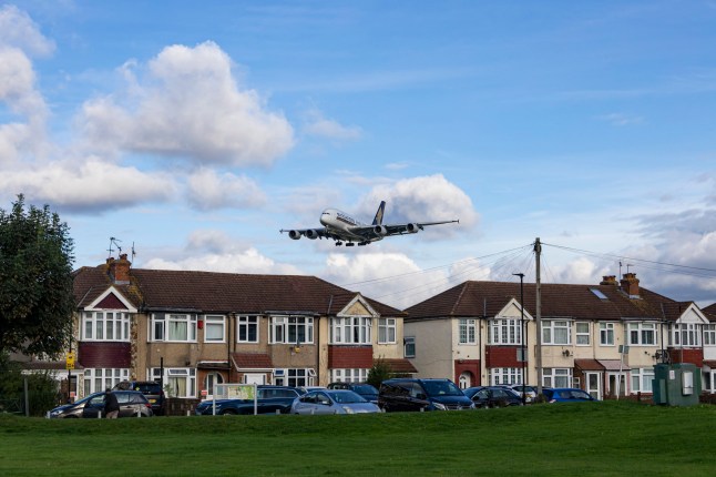 An airplane over houses near Heathrow Airport.