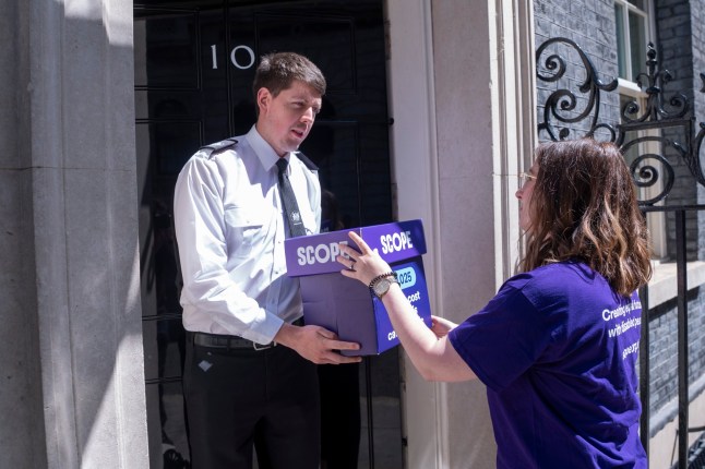 16.06.25_Scope-10.jpg - Jessica Leigh hands in the petition Jessica Leigh, campaigns manager at disability equality charity Scope, said: ?We?re here at Downing Street to urge the government to drop these catastrophic plans to rip billions from the welfare budget. ?More than 100,000 people have backed our petition against these cuts, including many disabled people. We?re joined at Downing Street by Rachel, Myles and Layla who are here urging the Prime Minister to listen. ?Life costs a lot more when you?re disabled, and these cuts will have a devastating effect on disabled people?s health, ability to live independently or work, as in Rachel?s case. ?Without PIP, she won?t be able to afford the things she needs to manage her conditions and the pain which comes with them, meaning she could no longer be able to work. ?The government must listen to disabled people and change course.?