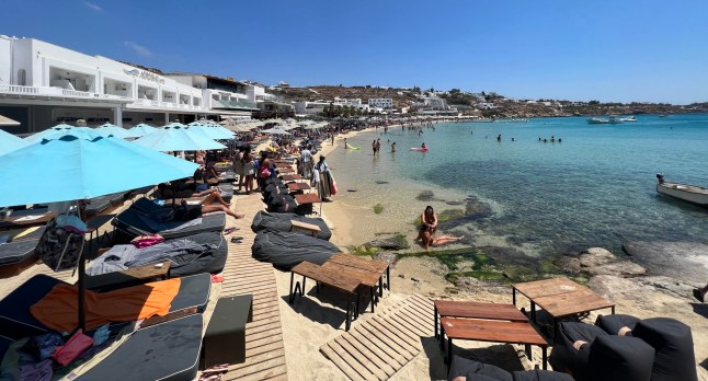 10/08/22 Paralia Platis Gialos beach DK Oyster Bar on Paralia Platis Gialos beach on Mykonos, Greece. DK Oyster Bar has been accused for ripping customers off by charging extremely expensive prices without telling customers costs first. Tourists have been taken by surprise when have been presented with the Bill.