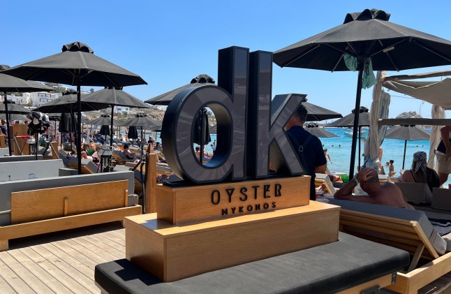 10/08/22 DK Oyster Bar on Paralia Platis Gialos beach on Mykonos, Greece. DK Oyster Bar has been accused for ripping customers off by charging extremely expensive prices without telling customers costs first. Tourists have been taken by surprise when have been presented with the Bill.