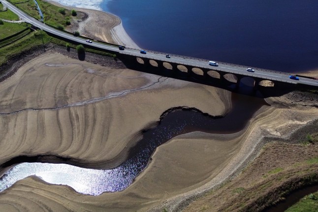 epa12095822 An aerial photograph taken with a drone shows the partially revealed bed of Woodhead Reservoir in Derbyshire, Britain, 13 May 2025. The UK Environment Agency has warned of the risk of a summer drought, as England has experienced the driest start to spring since 1956 due to below average rainfall and the sunniest April on record. EPA/ADAM VAUGHAN