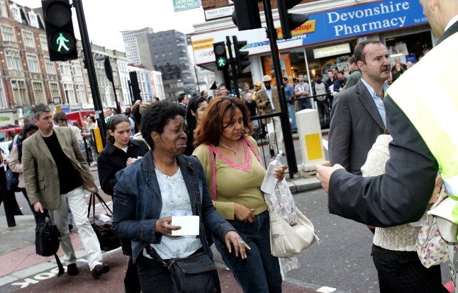 LONDON - JULY 7: Evacuated tube passengers fill the street at Edgware Road following an explosion which ripped through London's inderground tube network on July 7, 2005 in London, England. Blasts have been reported on the underground network and buses across the capital. (Photo by Gareth Cattermole/Getty Images)