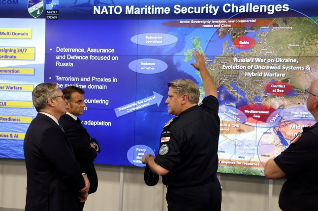 France's President Emmanuel Macron and Britain's Prime Minister Keir Starmer listen to a NATO military officer during a Coalition of the Willing meeting at a military base at Northwood Headquarters in north-west London, Britain, on July 10, 2025. LUDOVIC MARIN/Pool via REUTERS