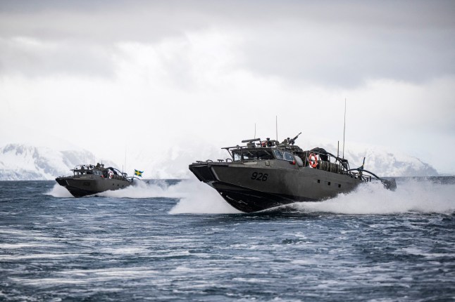 Swedish CB90-class fast assault craft in action during the Nordic Response 24 military exercise on March 10, 2024, at sea near Sorstraumen, above the Arctic Circle in Norway. Nordic Response 24 is part of the larger NATO exercise Steadfast Defender. The exercise involves air, sea, and land forces, with over 100 fighter jets, 50 ships, and over 20,000 troops practicing defensive manoeuvres in cold and harsh weather conditions. (Photo by Jonathan NACKSTRAND / AFP) (Photo by JONATHAN NACKSTRAND/AFP via Getty Images)