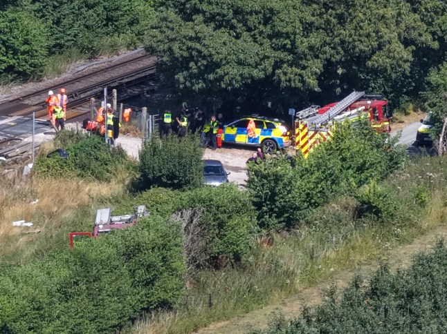 A London-bound train has collided with a van on a level crossing near Lower Road in Teynham, resulting in the death of the van driver, who is understood to have been an Amazon delivery driver. The collision occurred at high speed just after 12:45pm and caused the van to catch fire. Emergency services, including Kent Police, British Transport Police, and the air ambulance, attended the scene. The railway line between Newington and Faversham remains blocked in both directions, and a major investigation is underway. Official Police Statement In a statement issued this afternoon, British Transport Police said: ???Officers were called to the line in Tonge just after 12.45pm today (13 July) following reports of a train striking a van. Paramedics also attended, however sadly a person was pronounced dead at the scene. The incident is currently being investigated.??? 200 Passengers Evacuated Around 200 train passengers were trapped on board for several hours following the collision. They were eventually detrained and transferred to another train under the supervision of emergency crews. Road Closures and Disruption Several local road closures remain in effect while recovery and investigation work continues. Train services between Newington and Faversham are cancelled or delayed, and disruption is expected until at least 3:00pm. Southeastern and National Rail have advised passengers to check for live updates and seek alternative travel routes.